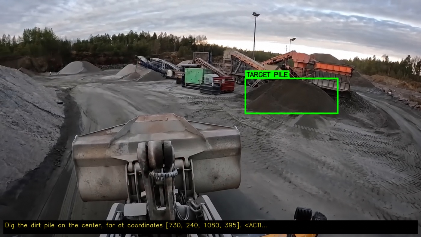 Wheel-loader camera frame with the predicted dig target boxed and the model's instruction overlaid
